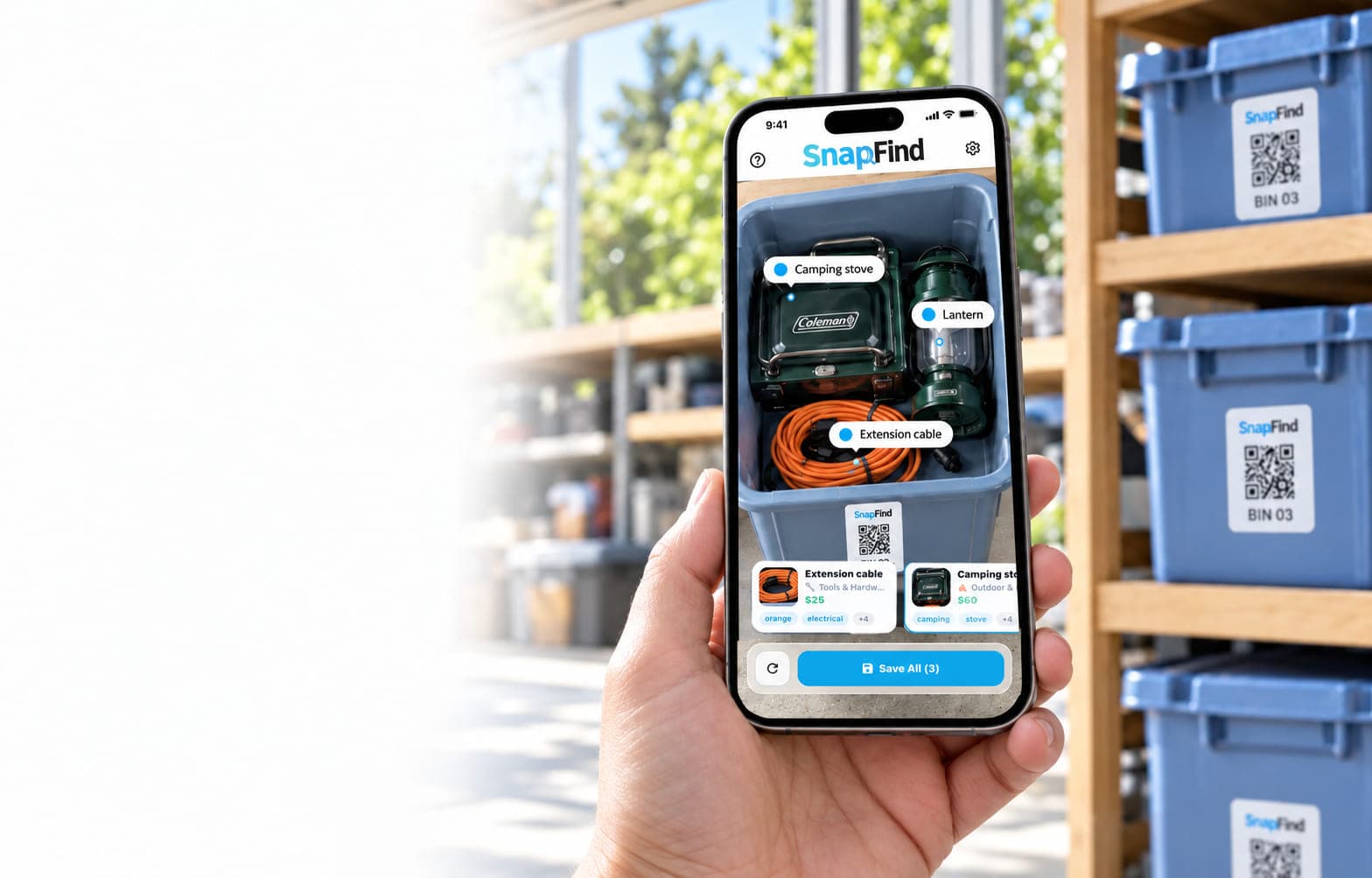 SnapFind on an iPhone photographing an open storage bin β the AI has labelled the camping stove, lantern and extension cable inside β in front of a shelf of QR-labelled SnapFind bins